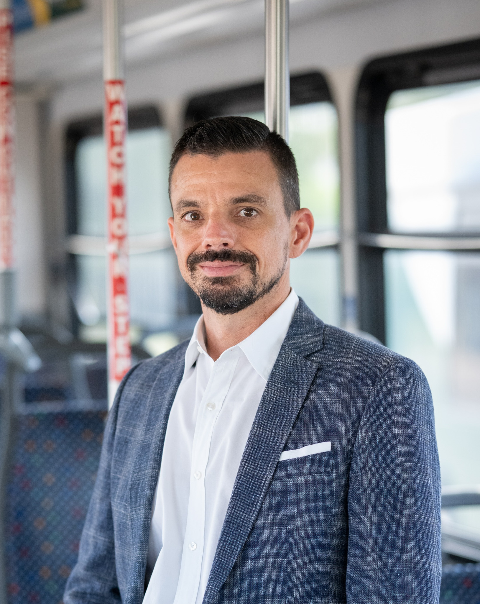 Headshot of Javier Trilla, Vice President of Innovation and Information Technologies, on a DCTA Connect Bus