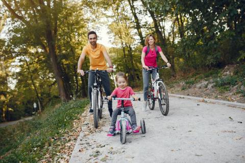 Family riding bikes on a trail